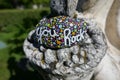 Kindness rock on part of old stone statue Royalty Free Stock Photo