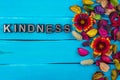 Kindness word on blue wood with flower Royalty Free Stock Photo