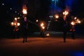 KINESHMA, RUSSIA - OCTOBER 09, 2021: Fire show with men and women with burning torches at a pyrotechnic performance