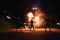 KINESHMA, RUSSIA - OCTOBER 09, 2021: Fire show with men and women with burning torches at a pyrotechnic performance