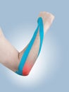 Kinesio tex tape therapeutic treatment of the elbow Royalty Free Stock Photo