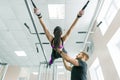 Kinesis technology, kinesitherapy, healthy lifestyle. Young woman doing rehabilitation exercises with personal instructor using Royalty Free Stock Photo