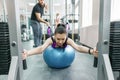 Kinesis technology, kinesitherapy, healthy lifestyle. Young woman doing rehabilitation exercises with personal instructor using