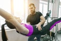 Kinesis technology, kinesitherapy, healthy lifestyle. Young woman doing rehabilitation exercises with personal instructor using Royalty Free Stock Photo