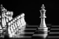 The King in battle chess game stand on chessboard with black iso