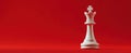 The King Chess Piece Standing Proud Against a Vibrant Red Background AI generated image Royalty Free Stock Photo