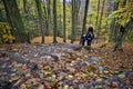 Hiking uphill with a child over the father`s shoulder in autumn Royalty Free Stock Photo