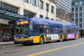 King County Metro blue and yellow bus on city street in Seattle