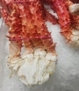 King crab legs bound with elastic bands displayed for sale on ice Royalty Free Stock Photo