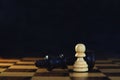 King encounters against powerful pawn in chess game, business competitive concept Royalty Free Stock Photo