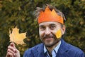 King of the fall. Funny bearded man in paper crown with yellow l