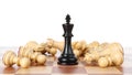 King among fallen chess pieces on wooden board against white background Royalty Free Stock Photo