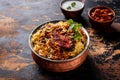 king fish biryani with raita served in a golden dish isolated on dark background side view food Royalty Free Stock Photo