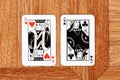 King of hearts card and Queen of clubs card placed side by side, facing each other, opposition and differences between man and Royalty Free Stock Photo