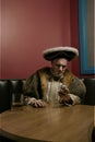 King Henry VIII using mobile phone at table