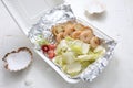 King prawn salad. Shrimp salad with iceberg lettuce in a take-away carton box, on a white background, top view. Royalty Free Stock Photo