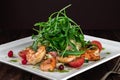 King prawn salad with tomatoes, arugula and grapefruit on a wooden table in a restaurant, close-up. Food for real gourmets Royalty Free Stock Photo