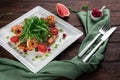 King prawn salad with tomatoes, arugula and grapefruit on a wooden table in a restaurant Royalty Free Stock Photo