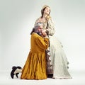 King, queen and kiss hand in studio for love, romance and bonding in drama, theatre or renaissance. Ancient royal couple