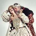 King, queen and love of couple in studio isolated on a gray background. Vintage royalty, retro victorian and affection