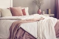 King size bed with pastel pink and white bedding in trendy bedroom interior Royalty Free Stock Photo