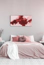 King size bed with pastel pink and white bedding in trendy bedroom Royalty Free Stock Photo