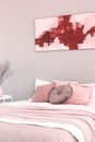 King size bed with pink and white bedding in trendy bedroom interior Royalty Free Stock Photo