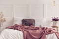 King size bed with white bedding and dirty pink blanket, real photo with copy space Royalty Free Stock Photo