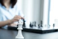 King standing in front of people hand move chess with strategy and tactic to win enemy, play battle on board game, business Royalty Free Stock Photo