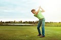 The king of swing. a man practicing his swing on the golf course. Royalty Free Stock Photo