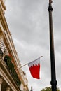 The Kingdom of Bahrain flag waving from the embassy balcony in London exterior view