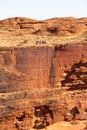 Group of visitors standing on the edge of Kings Canyon, red rocks formations in Kings Canyon, Petermann, Red Center, Australia