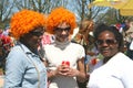 Women with orange wigs and diversity at Koningsdag (Kingsday), Amsterdam, Holland Royalty Free Stock Photo