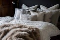 kingsize bed with a range of down pillows and fur blanket Royalty Free Stock Photo