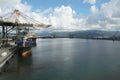 Kingston port with container ships under gantry crane operated by stevedores during cargo operation. Royalty Free Stock Photo