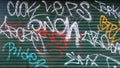 Graffiti Painted On A Green Metal Security Shutter