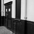 Locked Wooden Doors On A Building With Step Ladder Acces And A Drain Pipe And No People Royalty Free Stock Photo