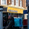 Starbucks Coffee Shop Lit By Morning Sunlight Royalty Free Stock Photo