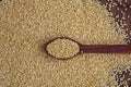 Kinoa seeds in wooden spoon on wooden table, top view Royalty Free Stock Photo