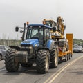 Farm tractor and loaded trailer on a highway in Southern Ireland.