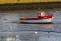 Kinsale, Ireland, vintage fishing boat resting during low tide