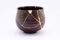 Kintsugi antique Japanese chawan restored with gold. Royalty Free Stock Photo