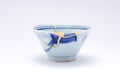 Blue sake cup repaired with the antique kintsugi real gold technique Royalty Free Stock Photo