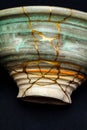 A kintsugi repaired bowl with gold. Royalty Free Stock Photo