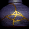 A kintsugi repaired vase with gold. Royalty Free Stock Photo