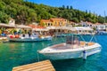 KIONI PORT, ITHACA ISLAND - SEP 19, 2014: boat on turquoise sea water in Kioni port. Greece is very popular holiday destination in