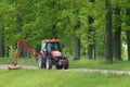 Kioti tractor mow grass in large park Royalty Free Stock Photo