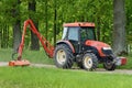 Kioti tractor mow grass in large park Royalty Free Stock Photo