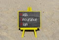 KIP kids insurance plan symbol. Concept words KIP kids insurance plan on beautiful yellow blackboard. Beautiful sand background.