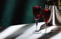 Kir Royale alcoholic cocktail with blackcurrant liqueur, prosecco and cocktail cherry. Dark green background, hard light and Royalty Free Stock Photo